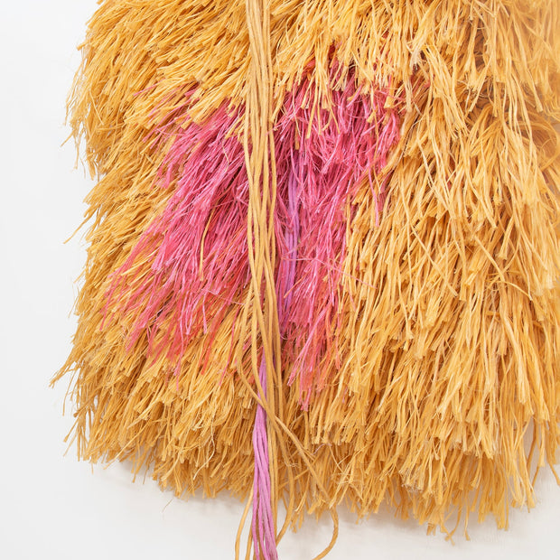 Textured yellow and pink yarn on a white background